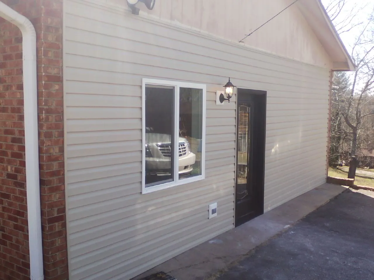 New vinyl siding and entry door on a room addition in Winburne
