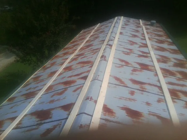 Rusted metal roof panels with new wood purlins before replacement — Storm Damage Roof Repair in Winburne by Roofing Brothers